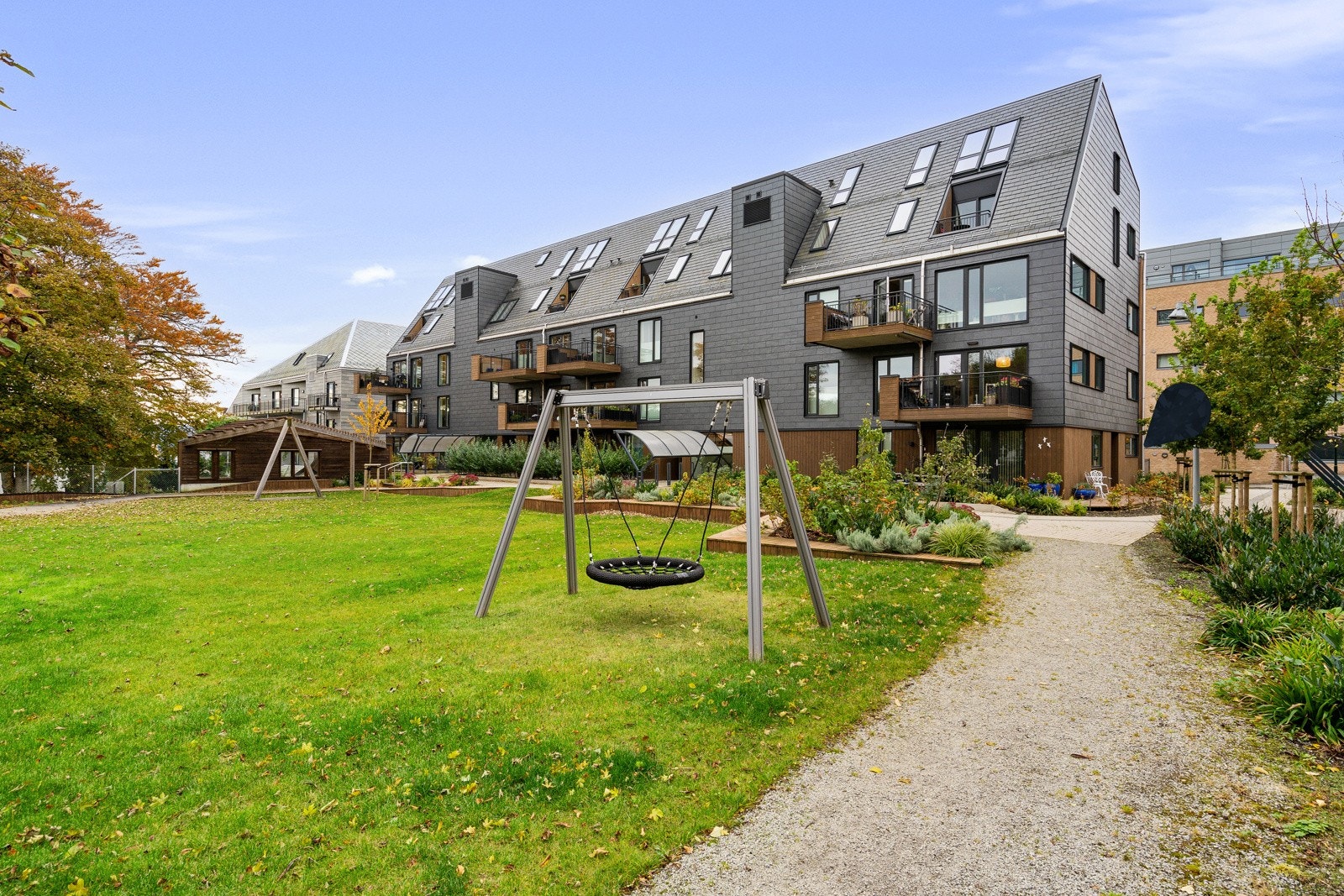 På fine sommerdager kan du også benytte deg av de frodige fellesarealene med pergola, benker, frukttrær og bugnende blomsterbed. Galleribilde