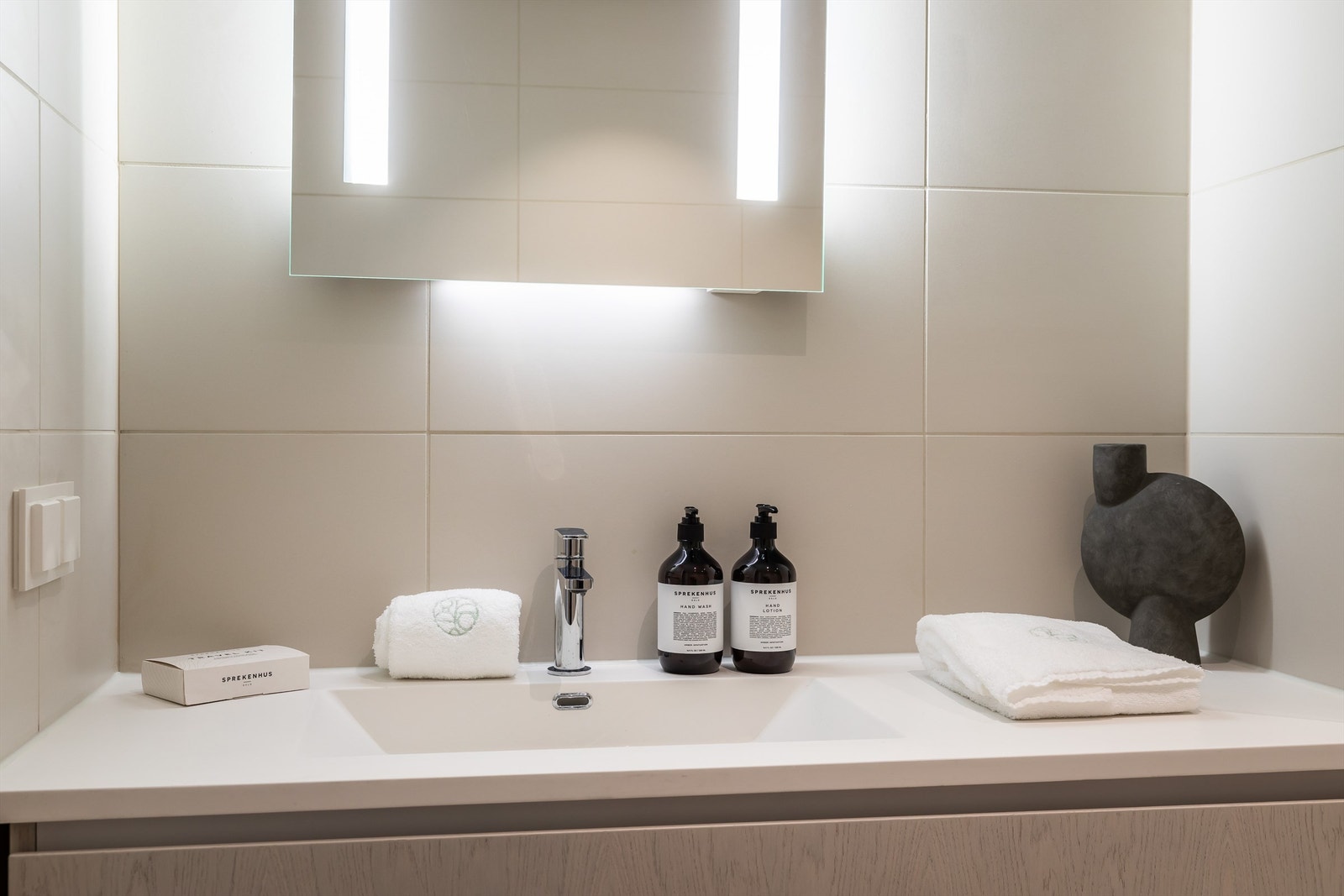 Det er opplegg for vaskemaskin. Dusjdører i klart glass med blankpolerte detaljer. Gulvvarme, downlights i himling og rør-i-rør system. Galleribilde