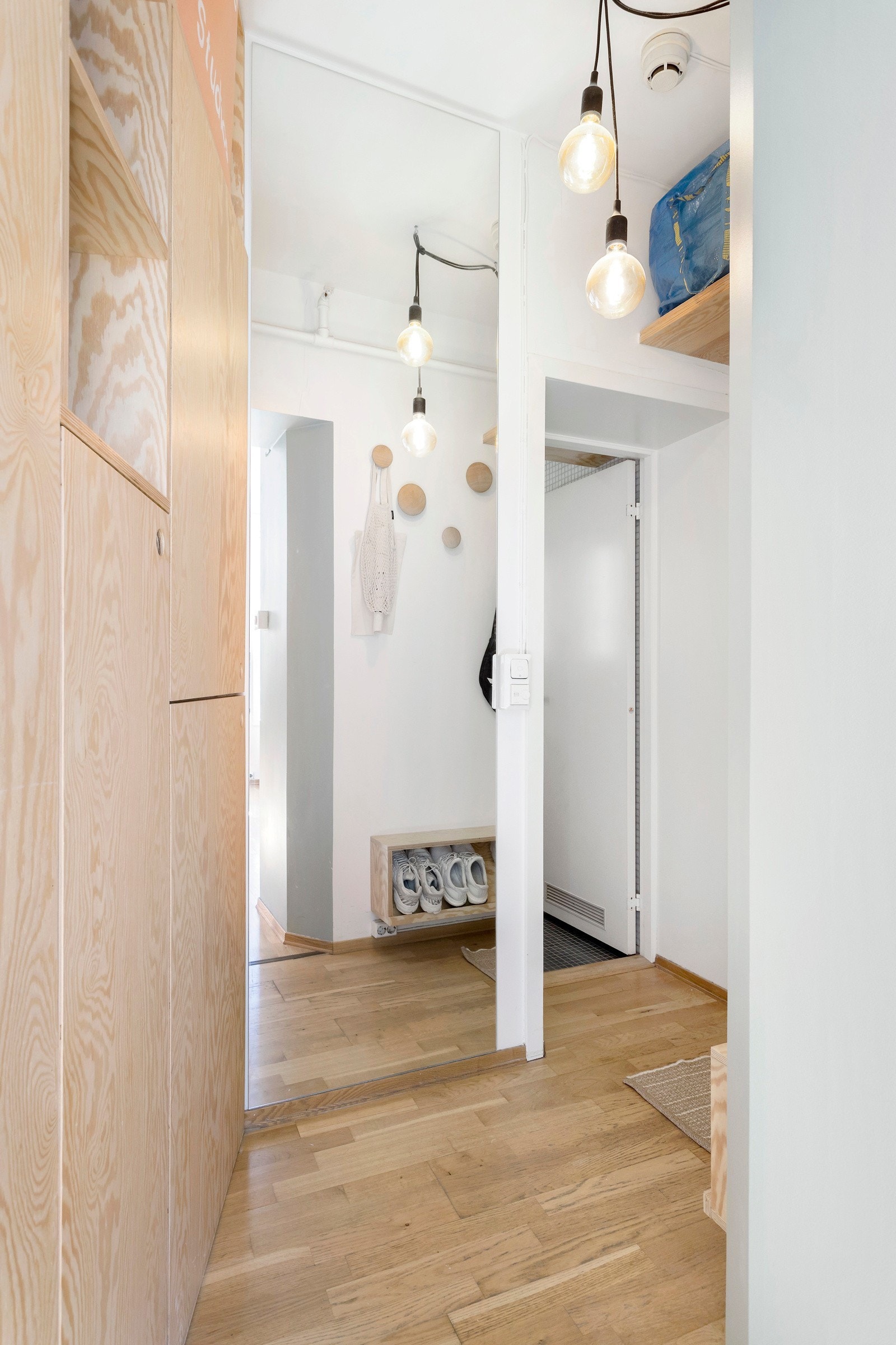 Langs den ene veggen i entréen er det hengt opp et stort speil fra gulv til tak som gjør til at entréen føles større og lysere. Galleribilde