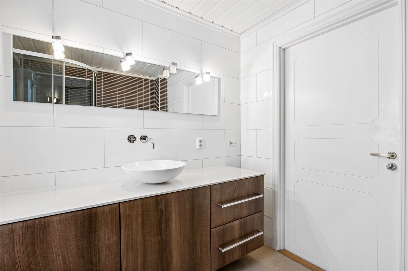 Badet har flislagte overflater, behagelig gulvvarme og downlights i himling. Galleribilde
