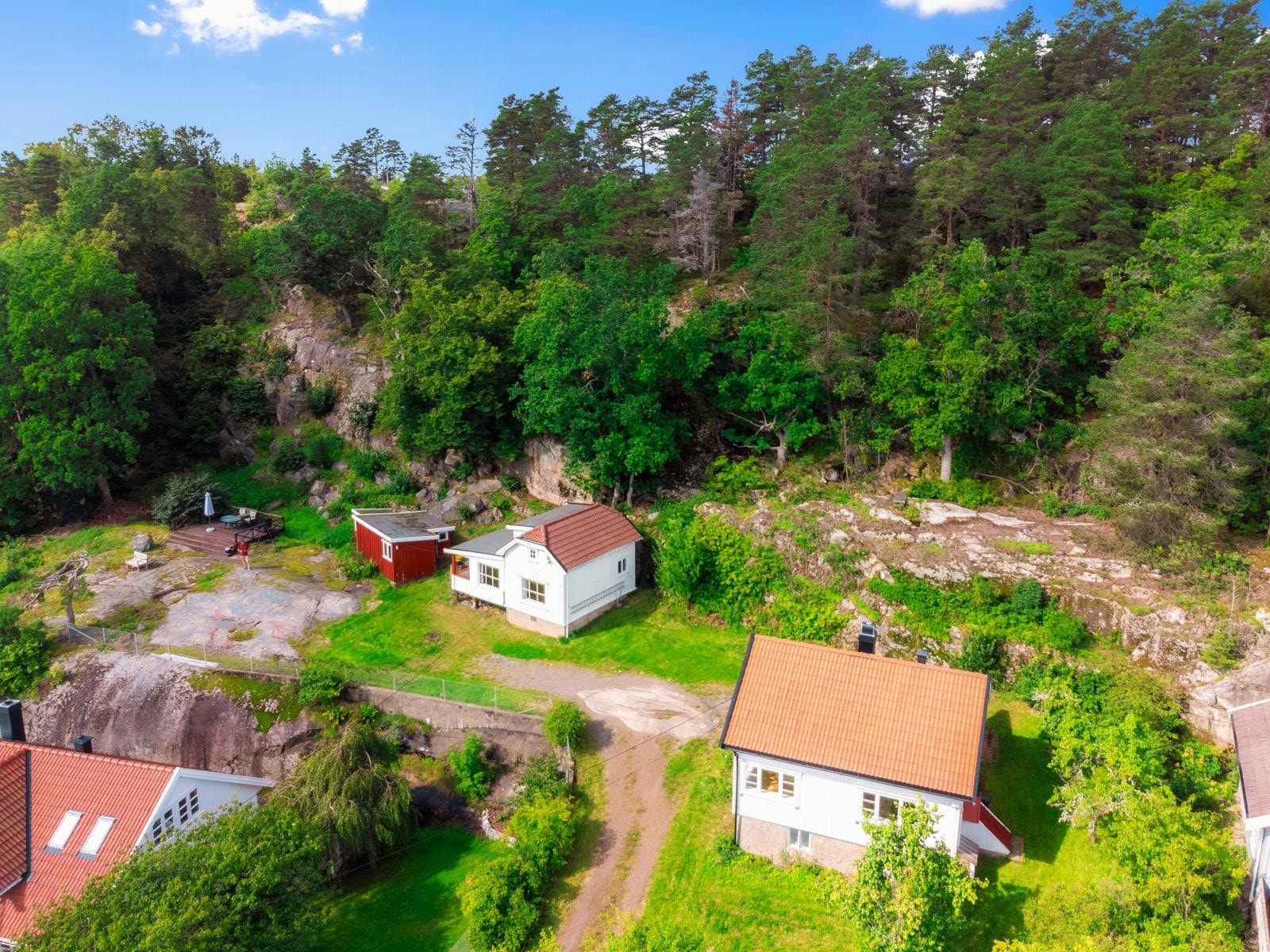 På vestsiden, på baksiden av huset, strekker tomten seg oppover fjellsiden. Galleribilde