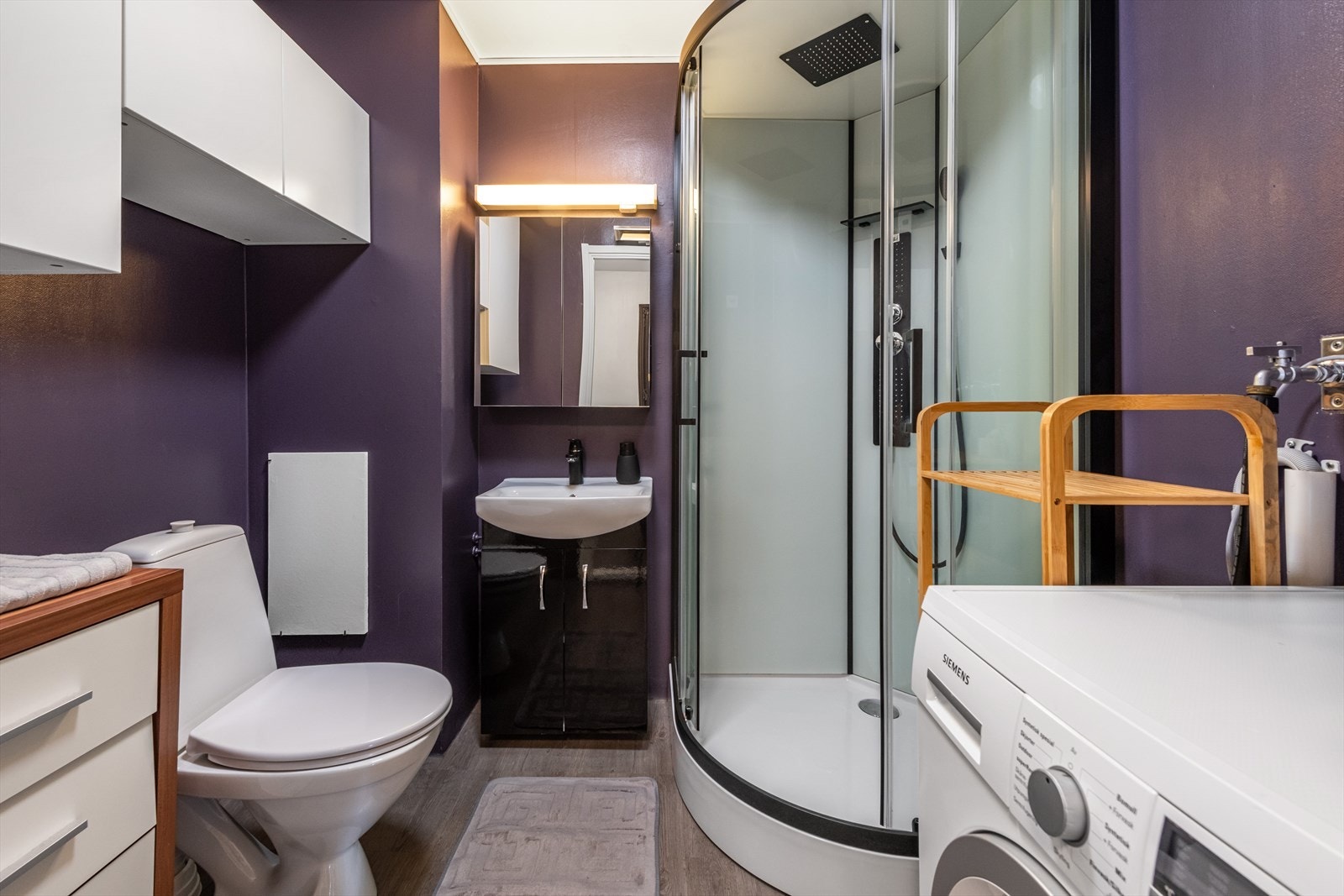 Badet er moderne og funksjonelt, utstyrt med et frittstående toalett og dusjkabinett. Galleribilde