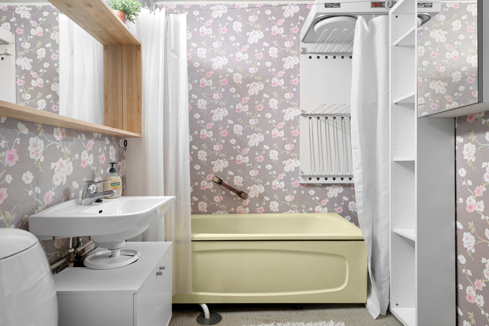 Lys baderomsinnredning, badekar og toalett. Galleribilde