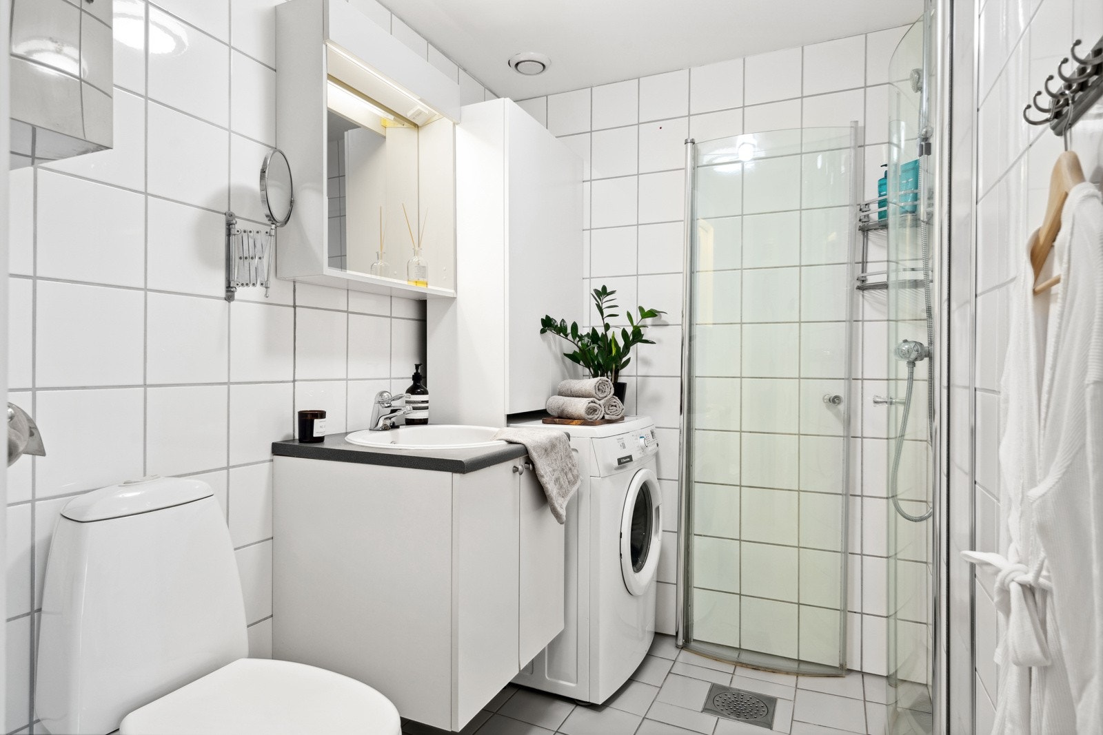 Arealeffektivt bad på 3,5m² med varme i gulv, ferdig opplegg for vaskemskin og praktisk dusjinnreding. Vaskemaskin medfølger dersom det er ønskelig. Galleribilde