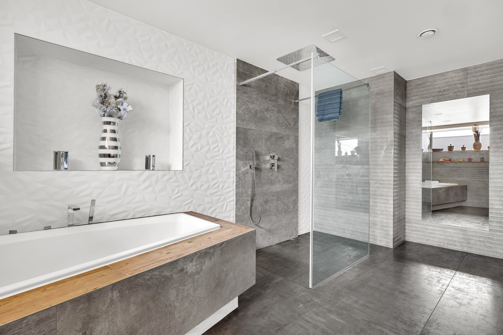 På det største badet i 1. etasje er det moderne badekar og takmontert regnfallsdusj. Galleribilde