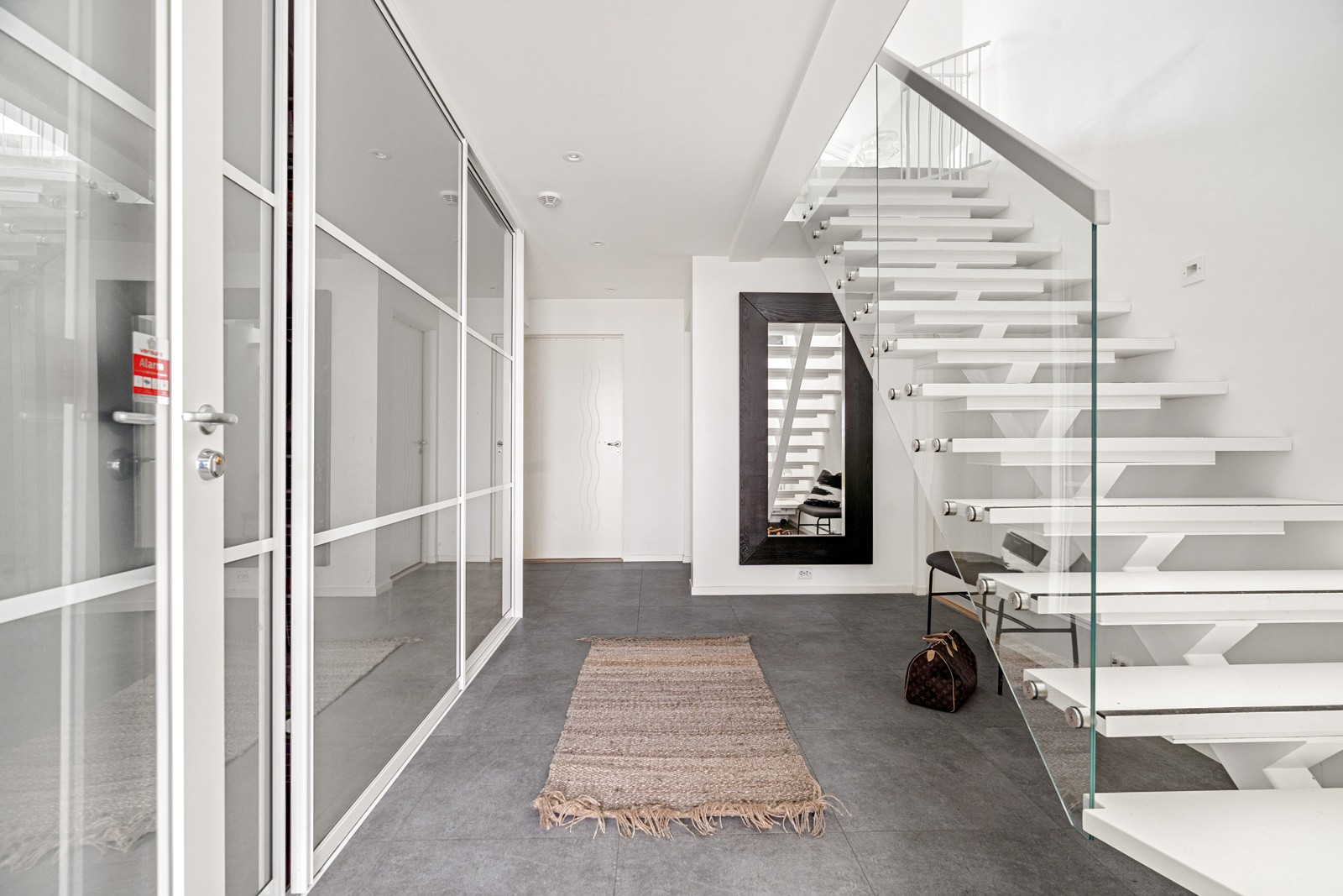 Entré av god størrelse med stor skyvedørsgarderobe som sikrer rikelig med oppbevaringsplass.