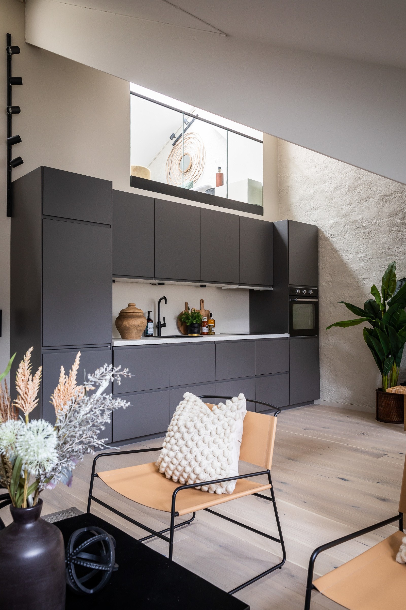 En åpen kjøkkenløsning som gir en enhetlig følelse hvor kjøkken og stue smelter sammen. Galleribilde