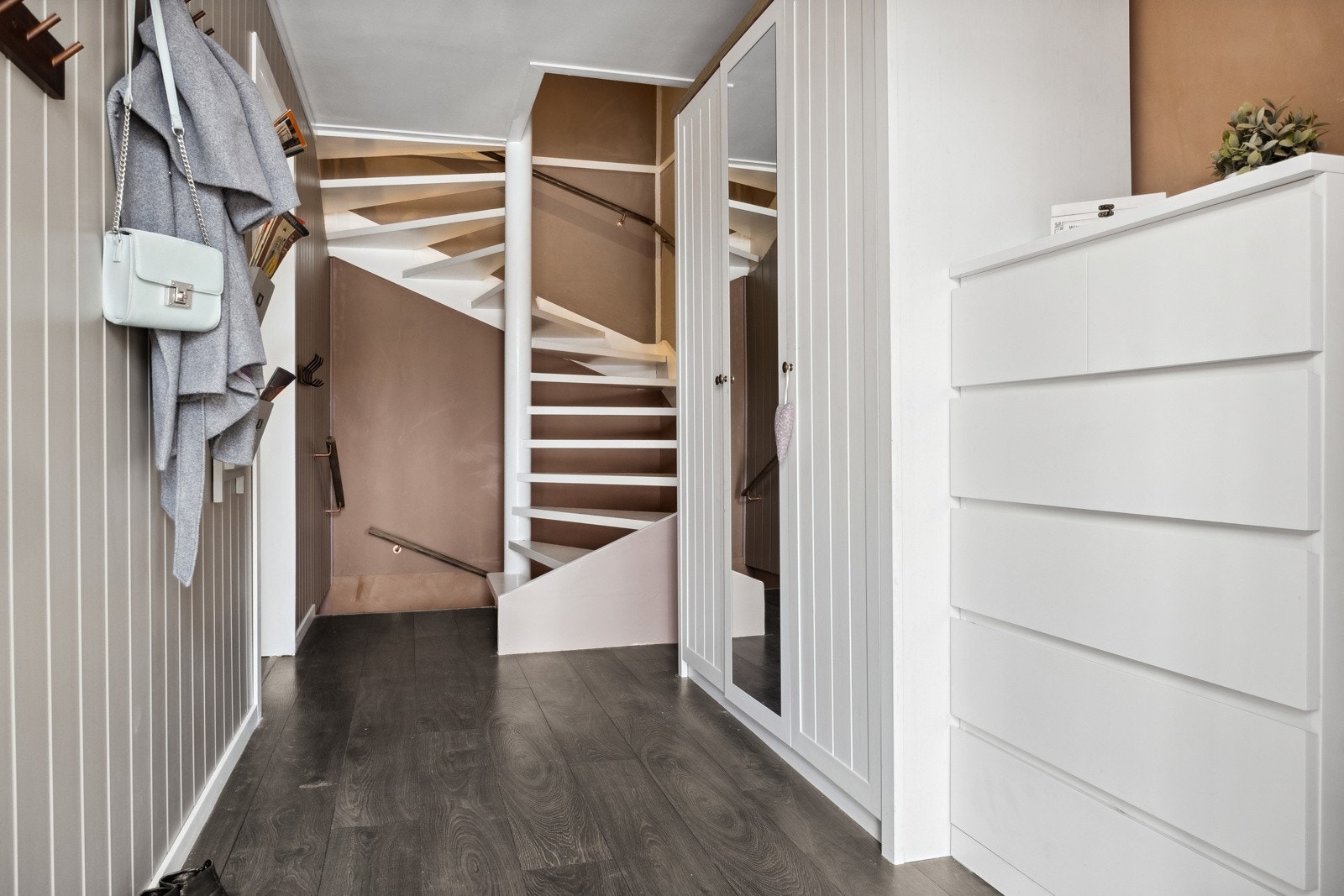 Rekkehuset har inngang til en trivelig entré med laminatgulv og trapp til etasjen over. Galleribilde