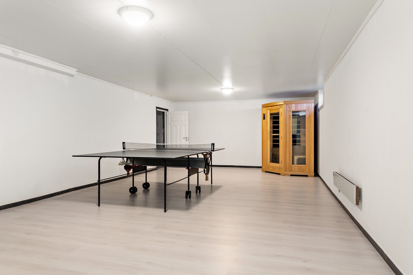 Nede i kjelleren finner du en romslig kjellerstue som også ble oppusset i 2022. Her er det montert en Jøtul 4 vedovn. Nye vinduer i 2020. Galleribilde