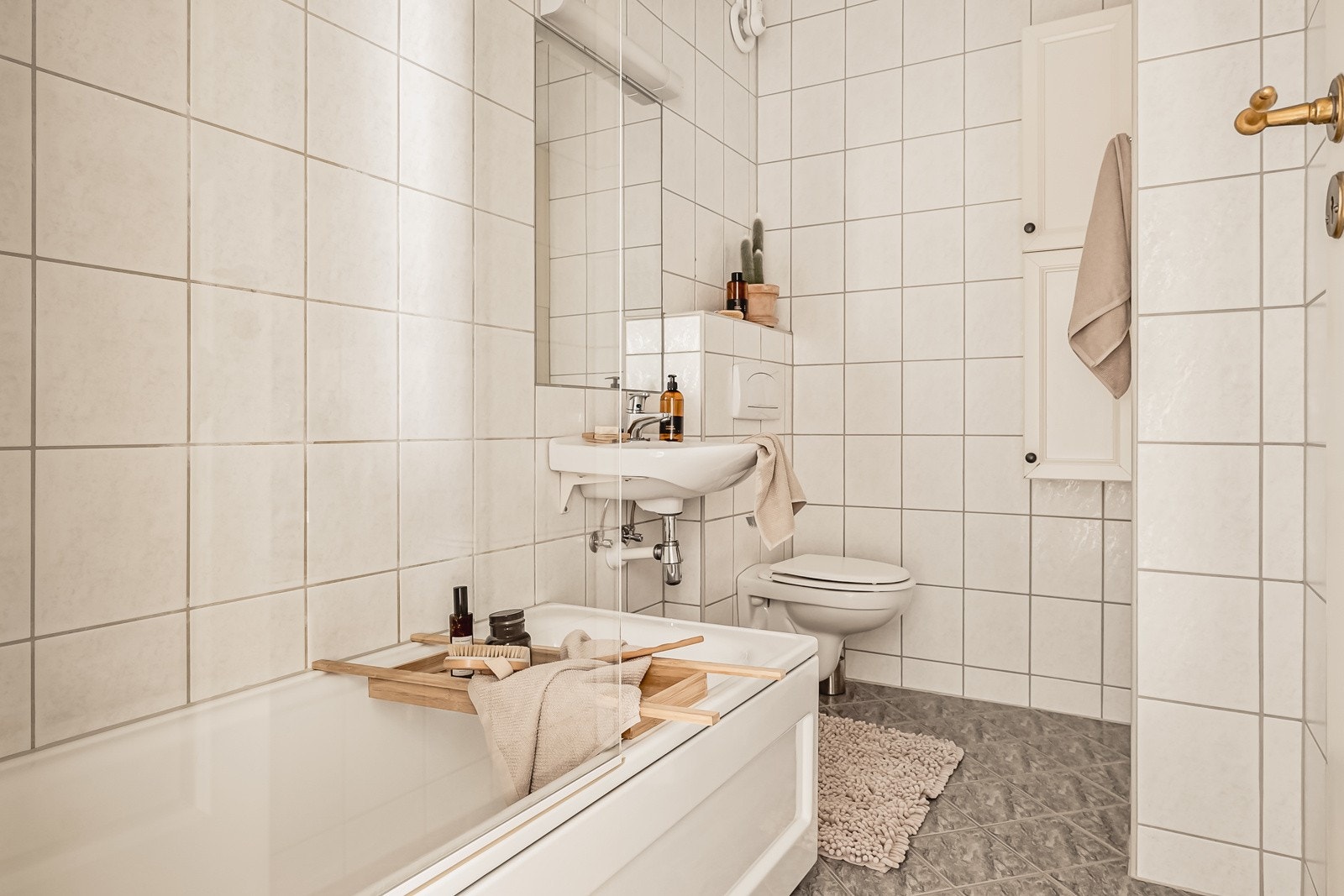 Flott bad som inneholder vegghengt toalett, helstøpt servant og badekar Galleribilde