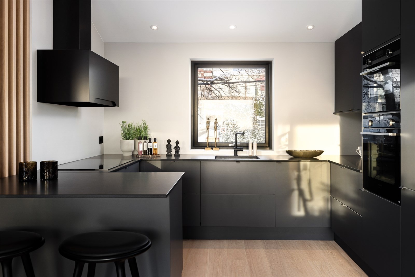 Sosial, åpen kjøkkenløsning med innredning fra Sigdal og eksklusiv benkeplate i granitt med underlimt kum. Galleribilde