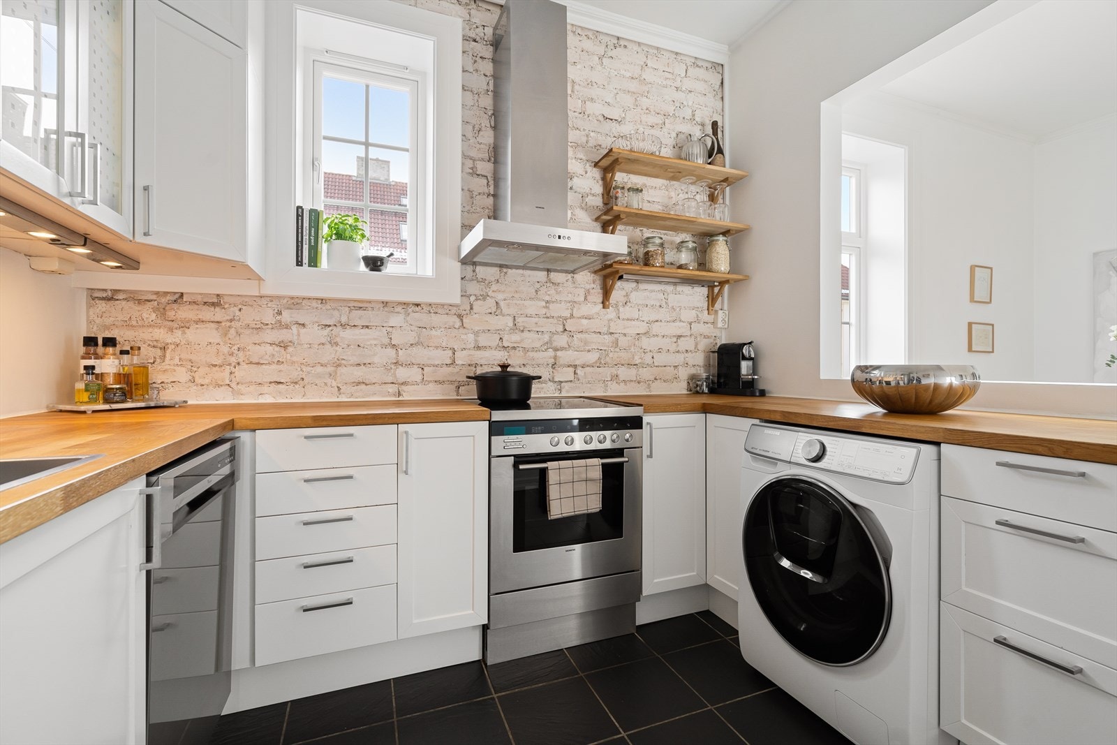 Kjøkkeninnredning med malte profilerte fronter, benkeplate med nedfelt vaskekum og malte overflater over benkeplaten. Galleribilde