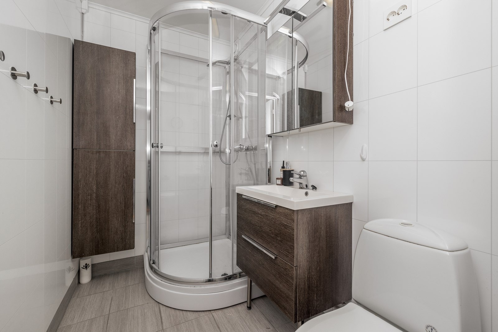 Lyst og pent baderom som i senere tid er overflateoppusset. Badet er utstyrt med elektriske varmekabler og dusjkabinett. Toalett av eldre standard. Galleribilde