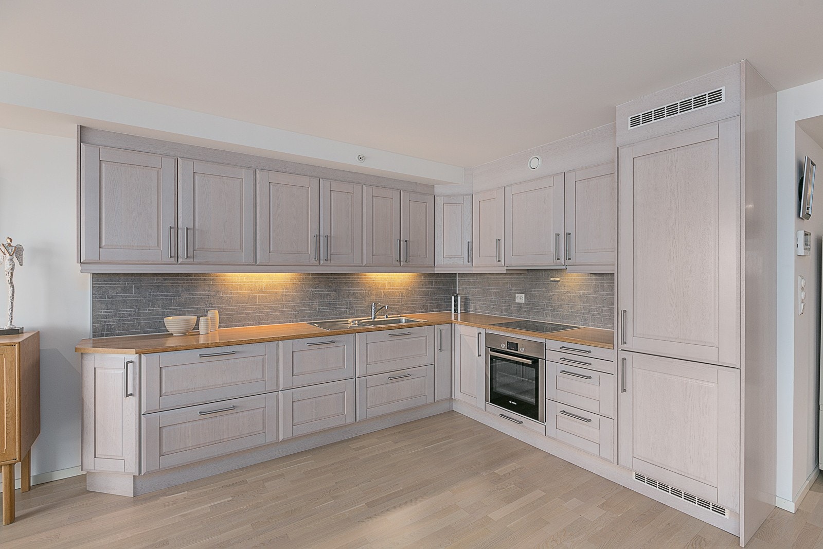 Pent kjøkken med integrerte hvitevarer og godt med skapplass. Galleribilde