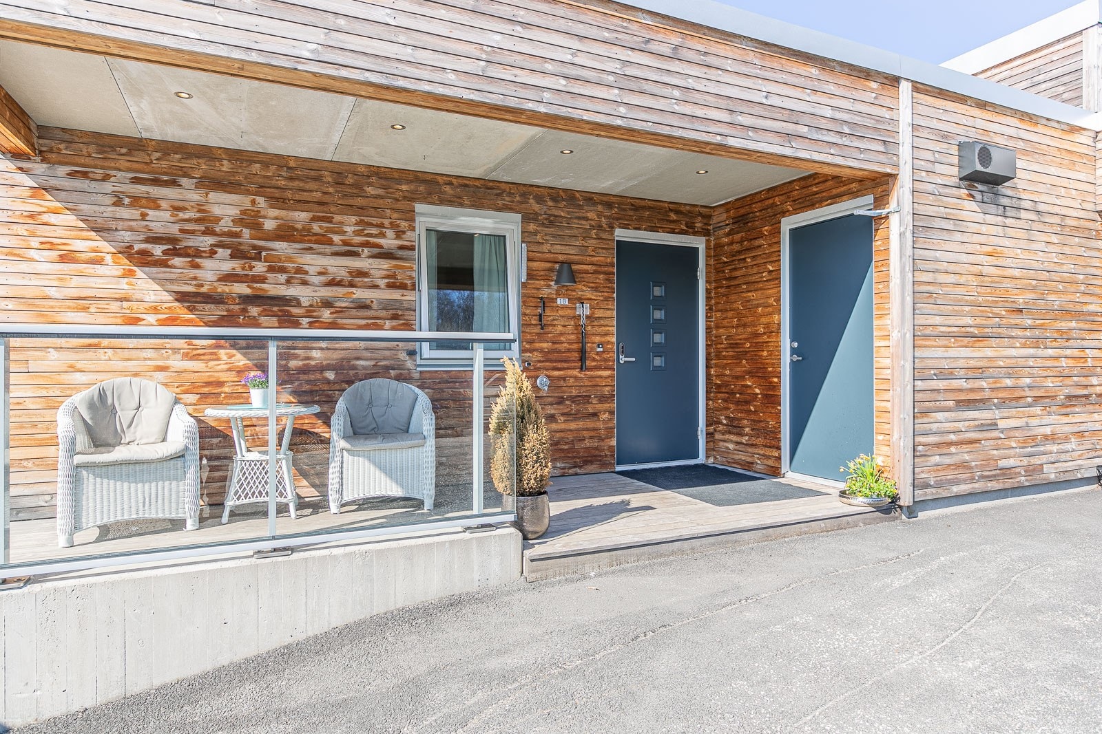 Overbygd inngangsparti med plass til sittegruppe. Galleribilde