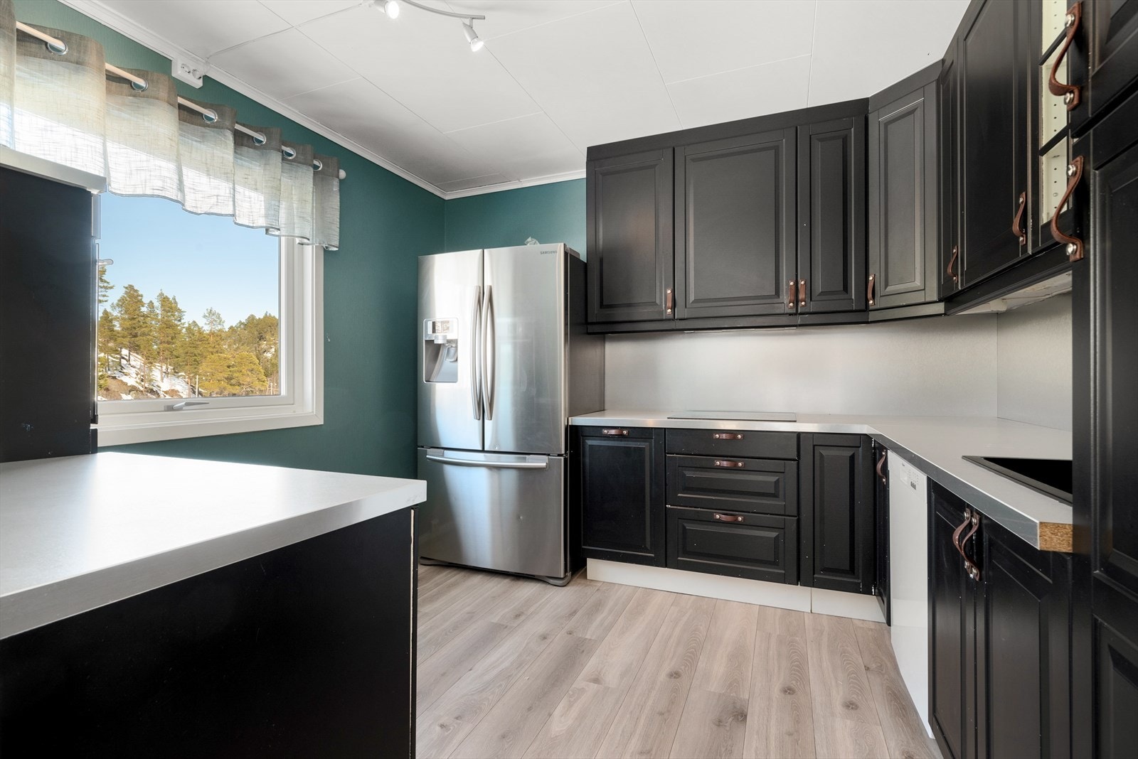 Kjøkkenet er stort og kan by på rikelig med skap og benkeplass Galleribilde