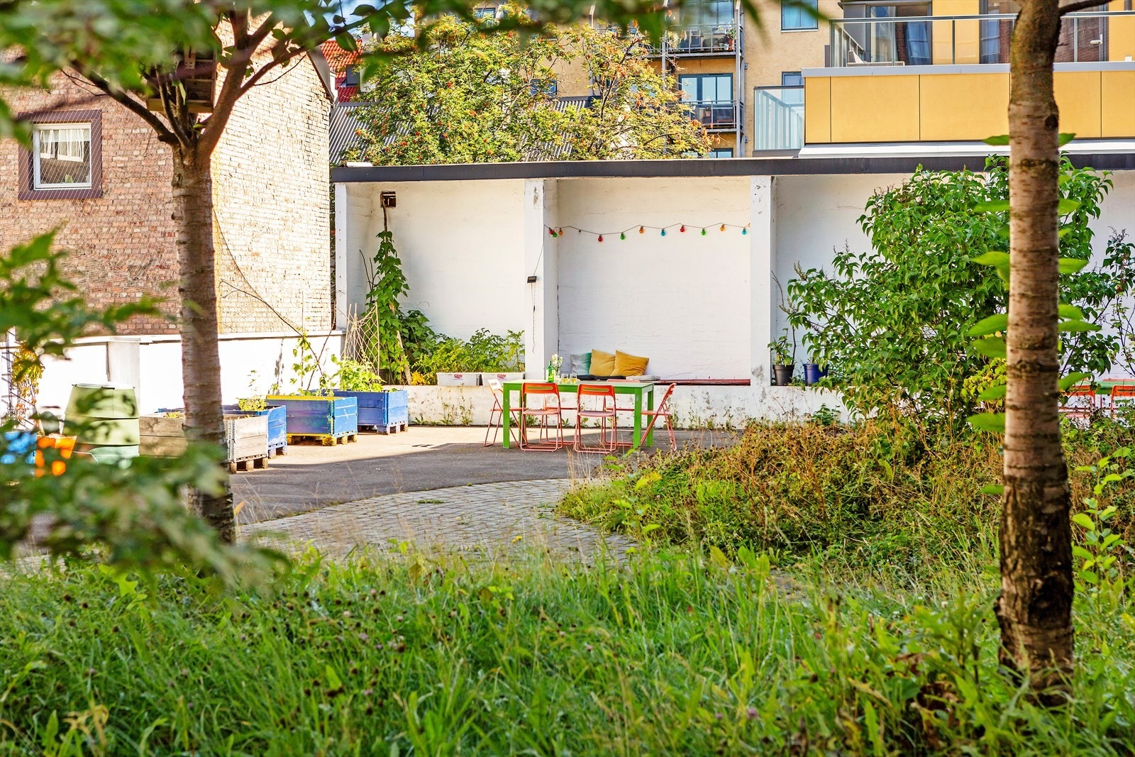 Sameiet har i tillegg en hyggelig bakgård med grill, fargeglade utemøbler, belysning og beplantning. Galleribilde