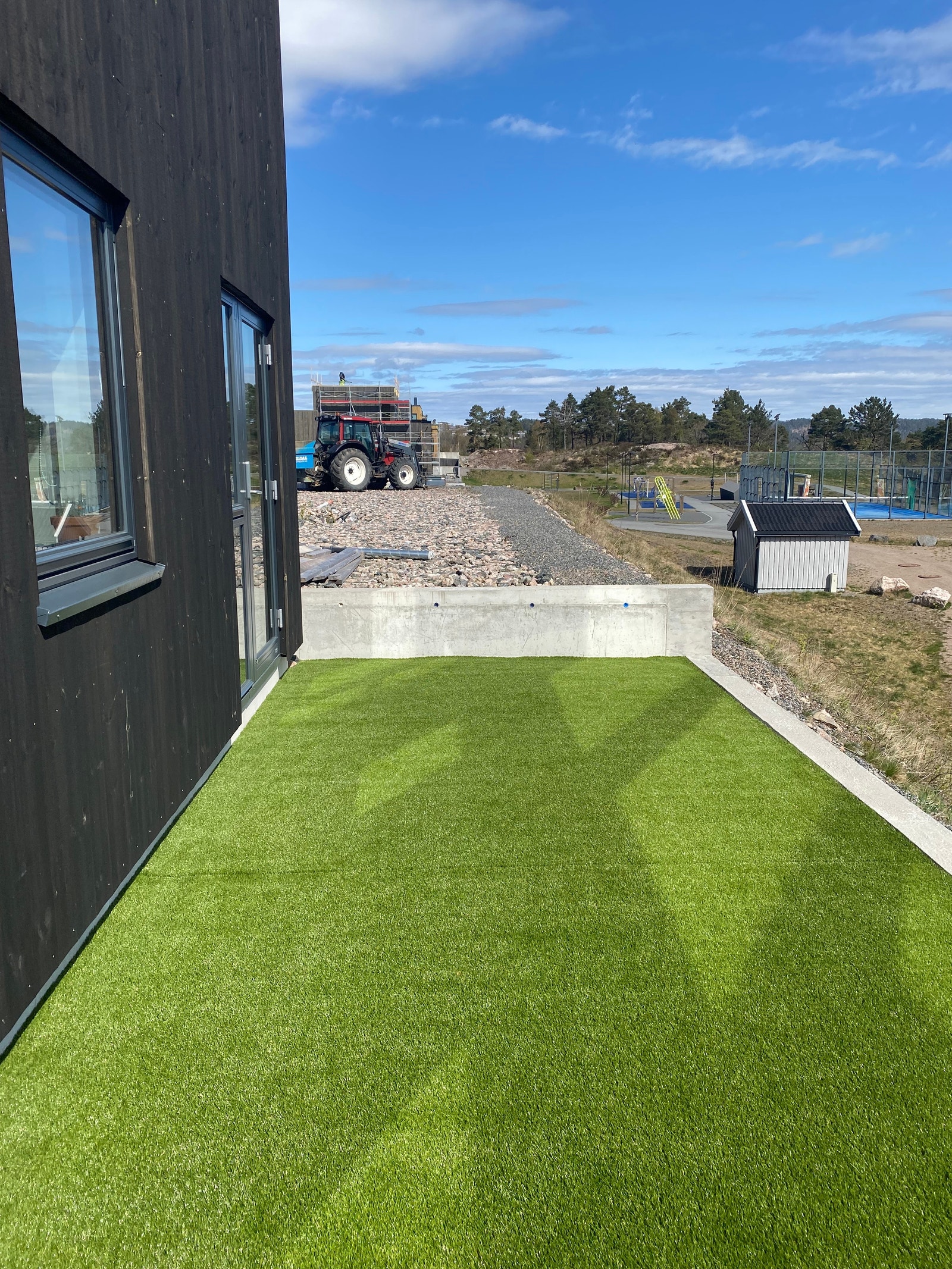 Det er lagt kunstgress bak huset, og nylig bygget gjerder for et mer privat uteområde. En del av denne får beboeren nyte godt av. Galleribilde