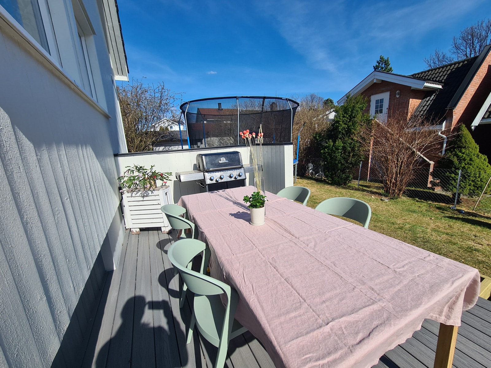 Spiseplass med grill og trampoline i bakgrunn Galleribilde