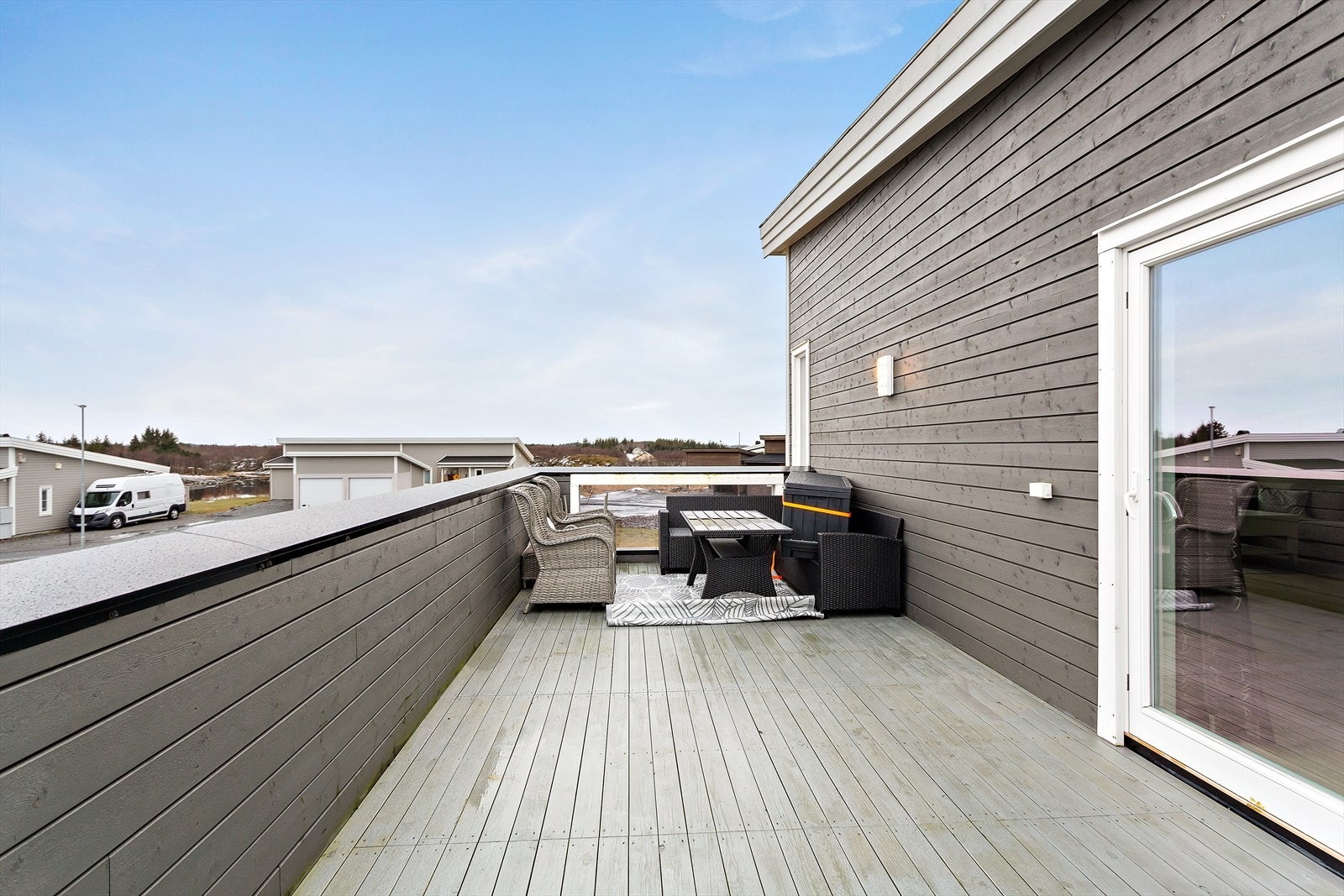 Terrasse over carport og utvendig bod har godt med plass. Med heldekkende rekkverk er det god ly for vind. Nydelig utsikt mot både sør og nord Galleribilde
