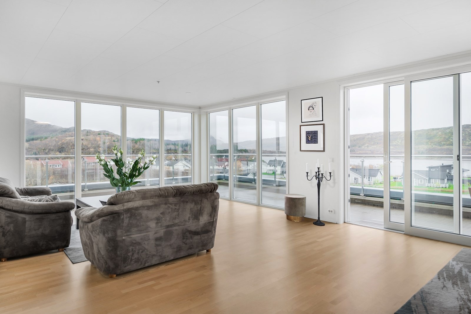 Videre kommer du inn til en stue med åpen løsning mot kjøkkenet. (Virtuell møblering). Galleribilde