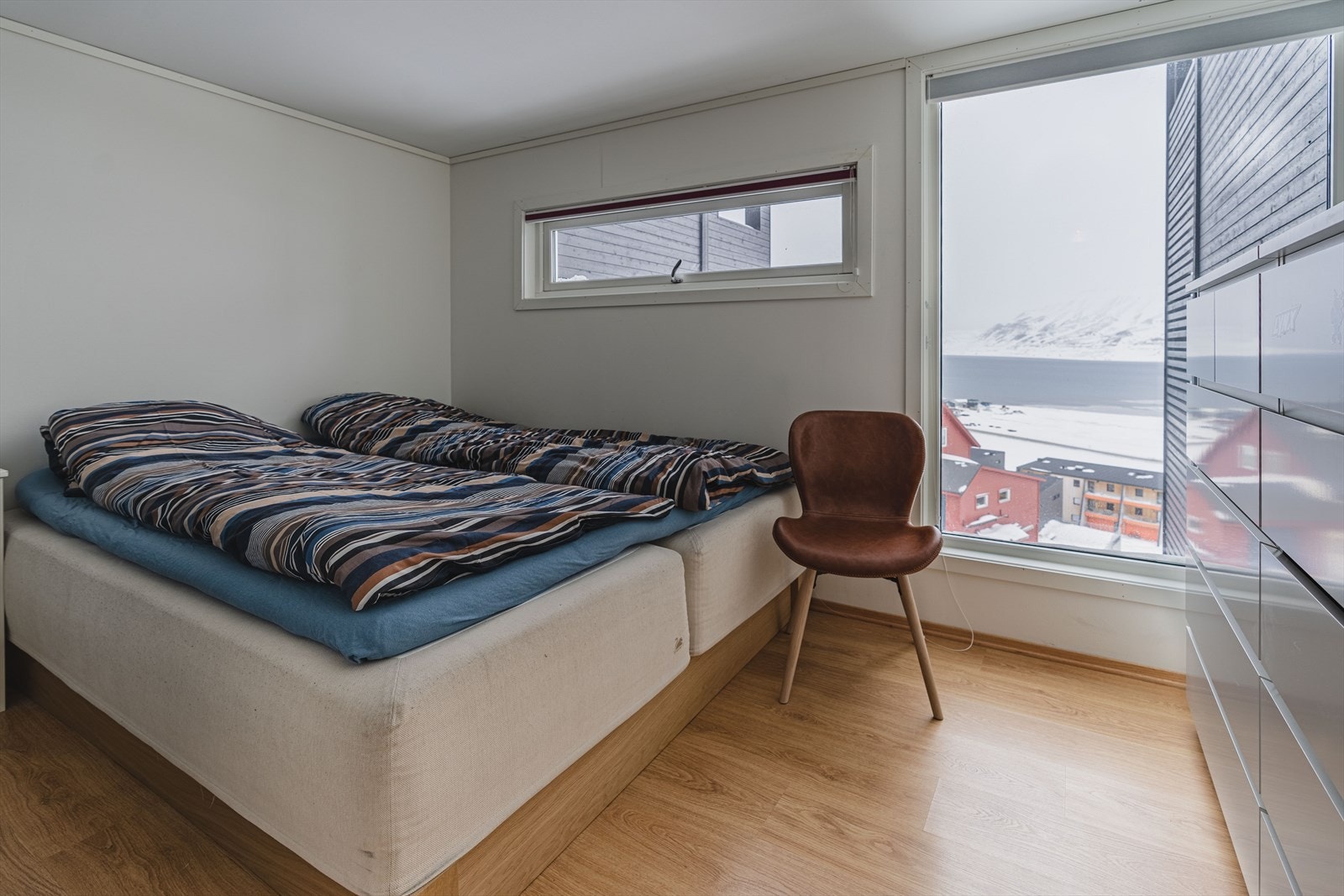 Det er 4 soverom i huset og det ene av disse befinner seg i 1. etasje. Her har du et vindu som går nesten fra gulv til tak og utsikten mot Hiortfjellet er magisk. Galleribilde