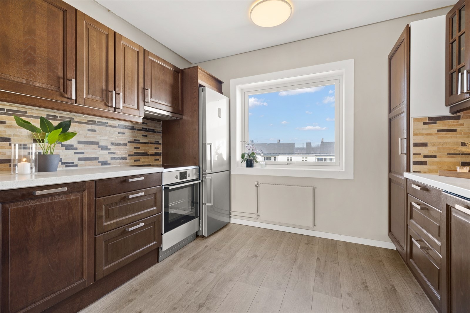 Kjøkkeninnredning med mye skap- og benkeplass Galleribilde