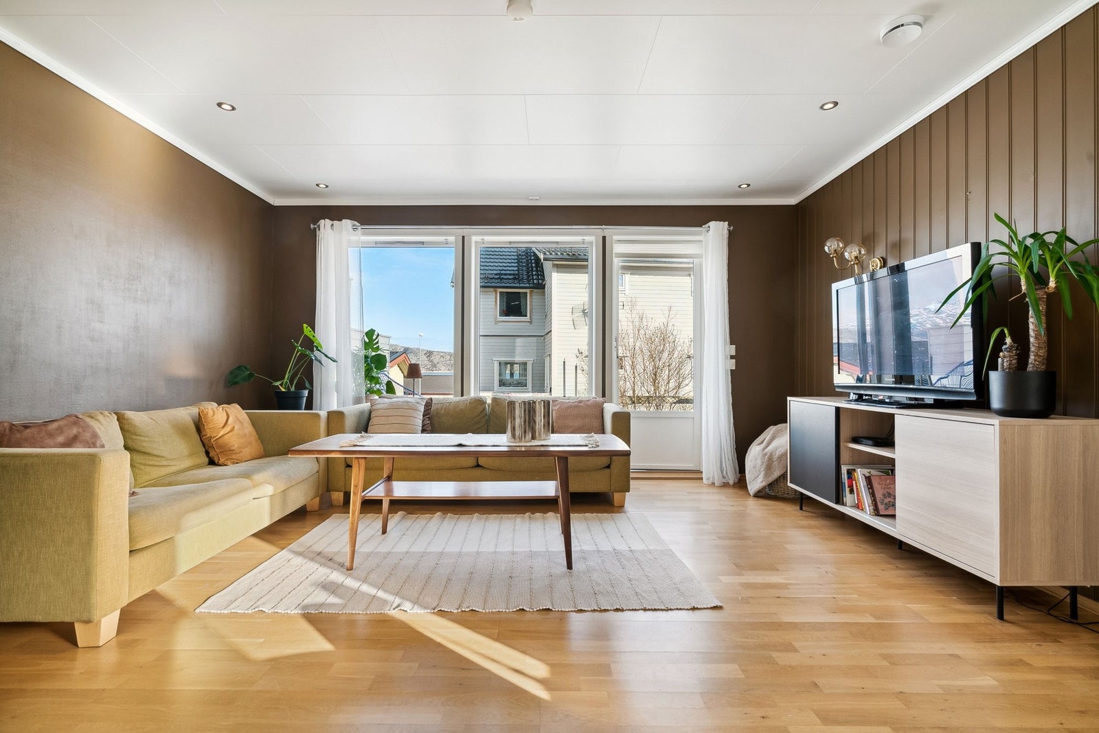 Store vinduer i stuen som gir mye naturlig lys inn i rommet. Galleribilde