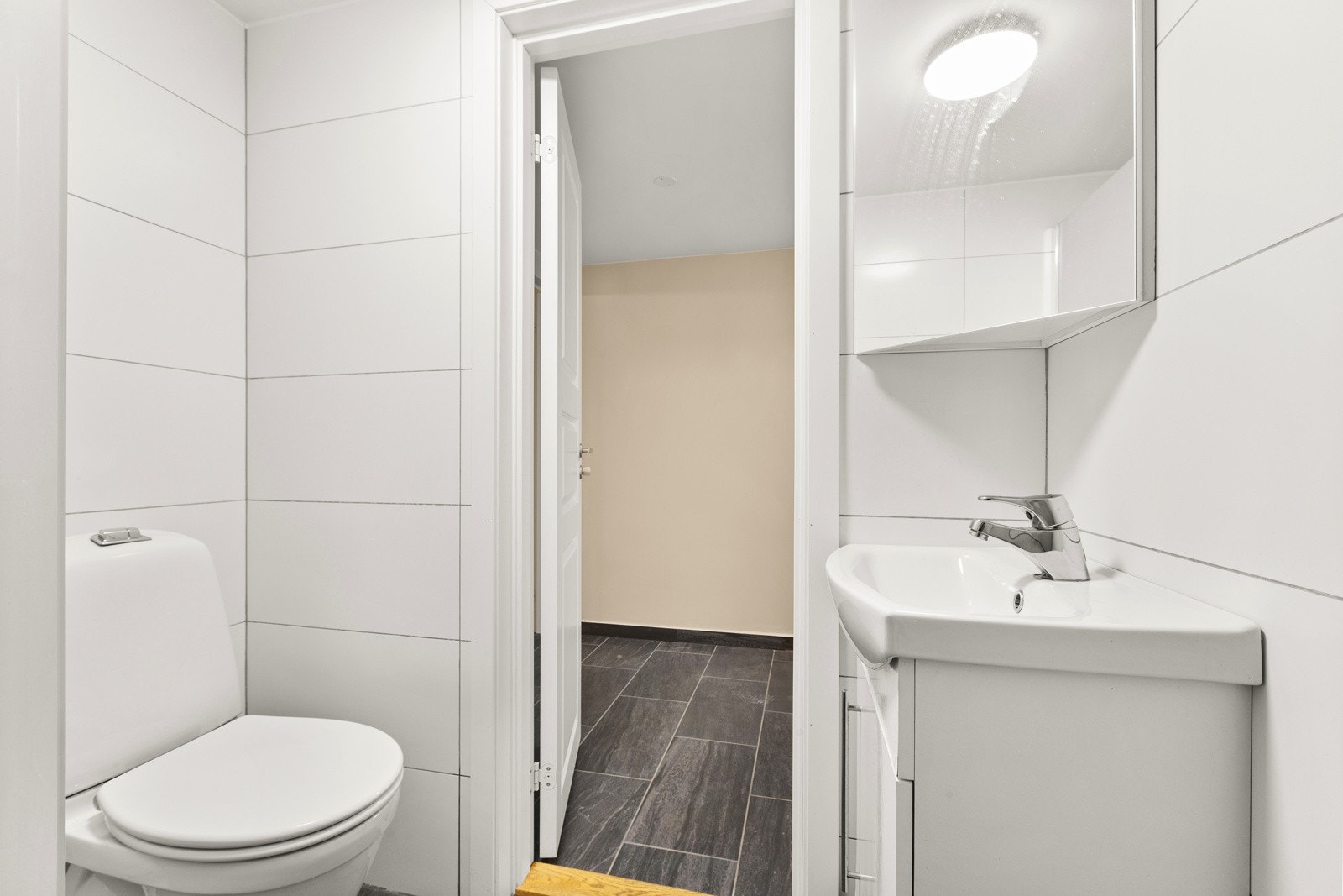 Badet er pent opparbeidet med store tidsriktige fliser Galleribilde