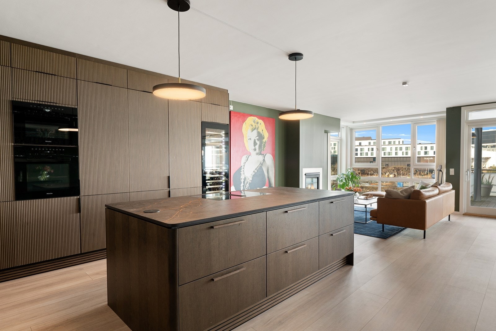 Leiligheten har en åpen stue-/kjøkkenløsning. Galleribilde