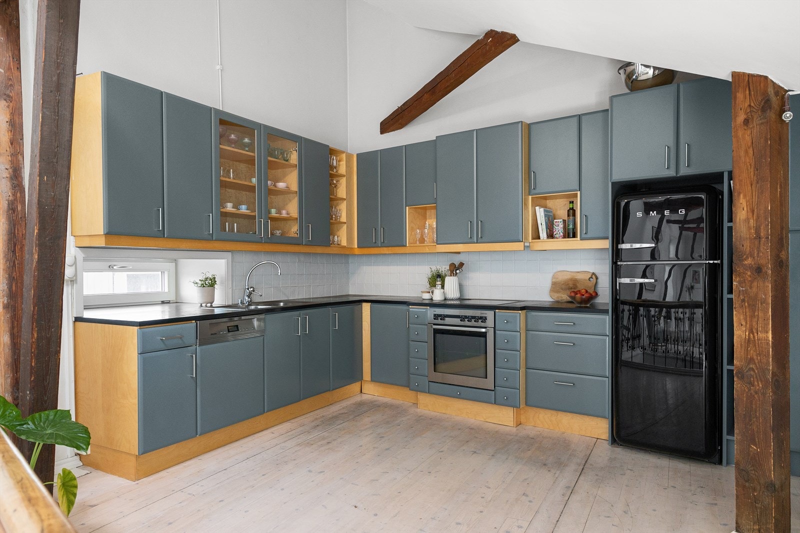 Nedfelt oppvaskkum i rustfritt stål og mekanisk avtrekksvifte over stekesonen. Galleribilde