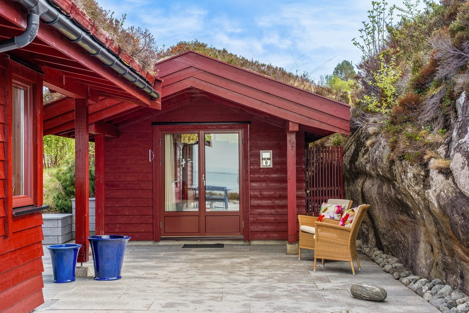 Flott steinlagt uterom mellom uthuset og hytten. Lunt og skjermet Galleribilde