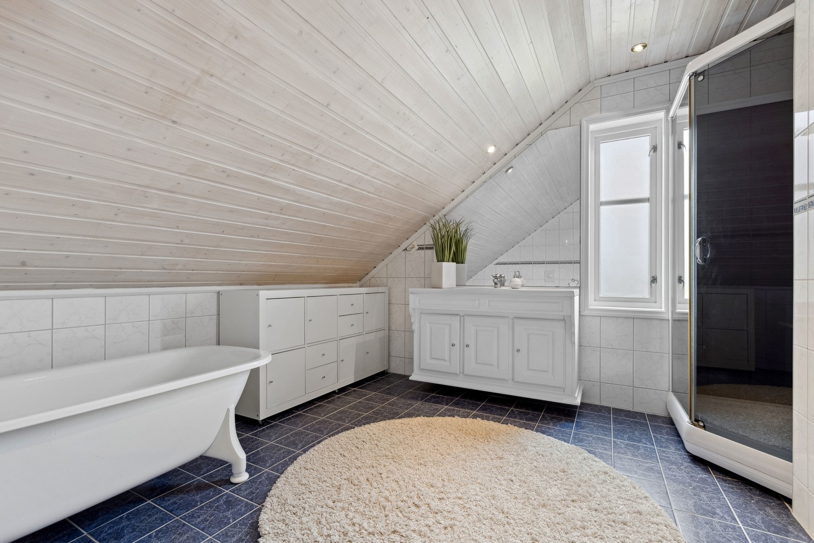 - Badet oppleves som romslig med pene flislagte overflater, pen innredning, badekar og dusjkabinett. Galleribilde