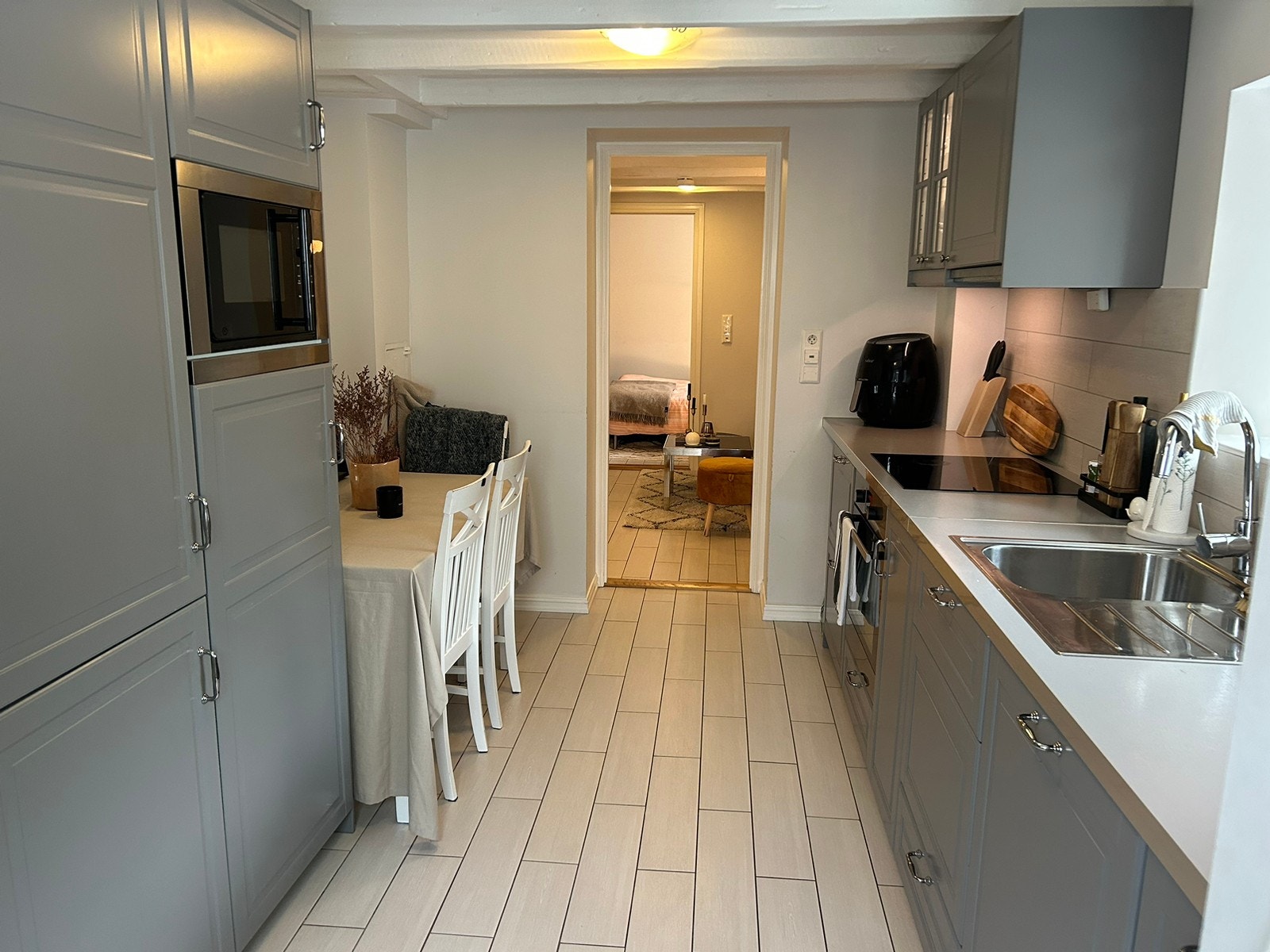 Kjøkken med spiseplass, induksjonstopp, ovn, oppvaskmaskin, mikrobølgeovn mv. Galleribilde