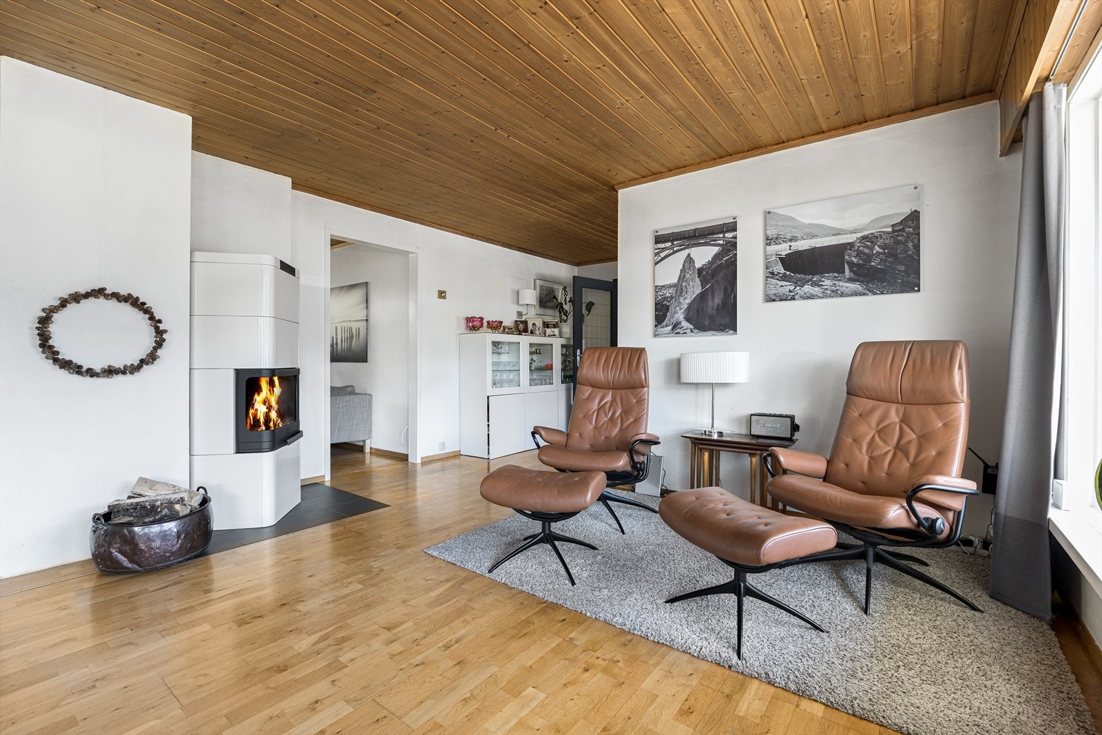 Romslig stue med plass til flere sittegrupper Galleribilde