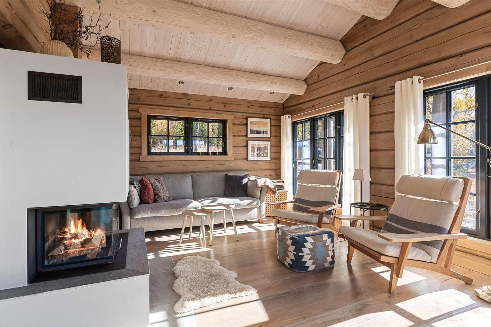 Lys og åpen stuen med en hyggelig peis som midtpunkt Galleribilde