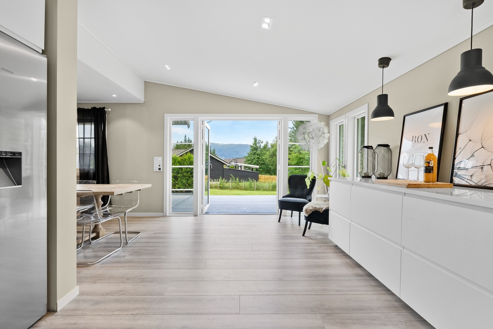 Fra kjøkkenet er det egen utgang til terrasse og hage på baksida av boligen Galleribilde