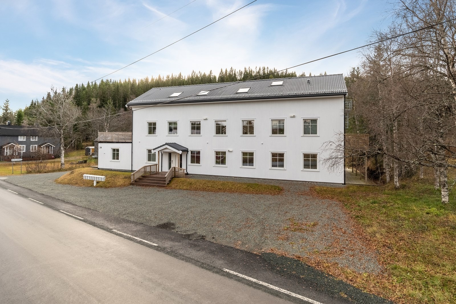 Fellesområdet er opparbeidet med grøntarealer og en gruset gårdsplass for parkering. Galleribilde