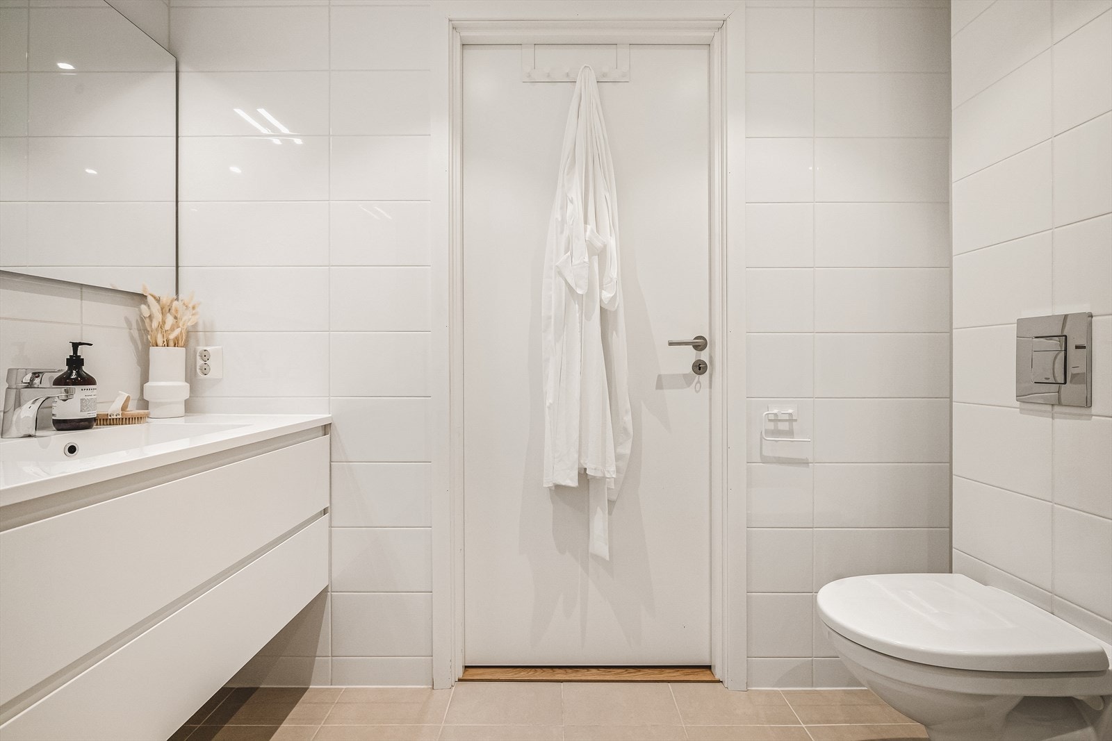 Badet har blitt innredet med wc, servant med møblement, speil, belysning og dusjnisje med foldedører. Galleribilde