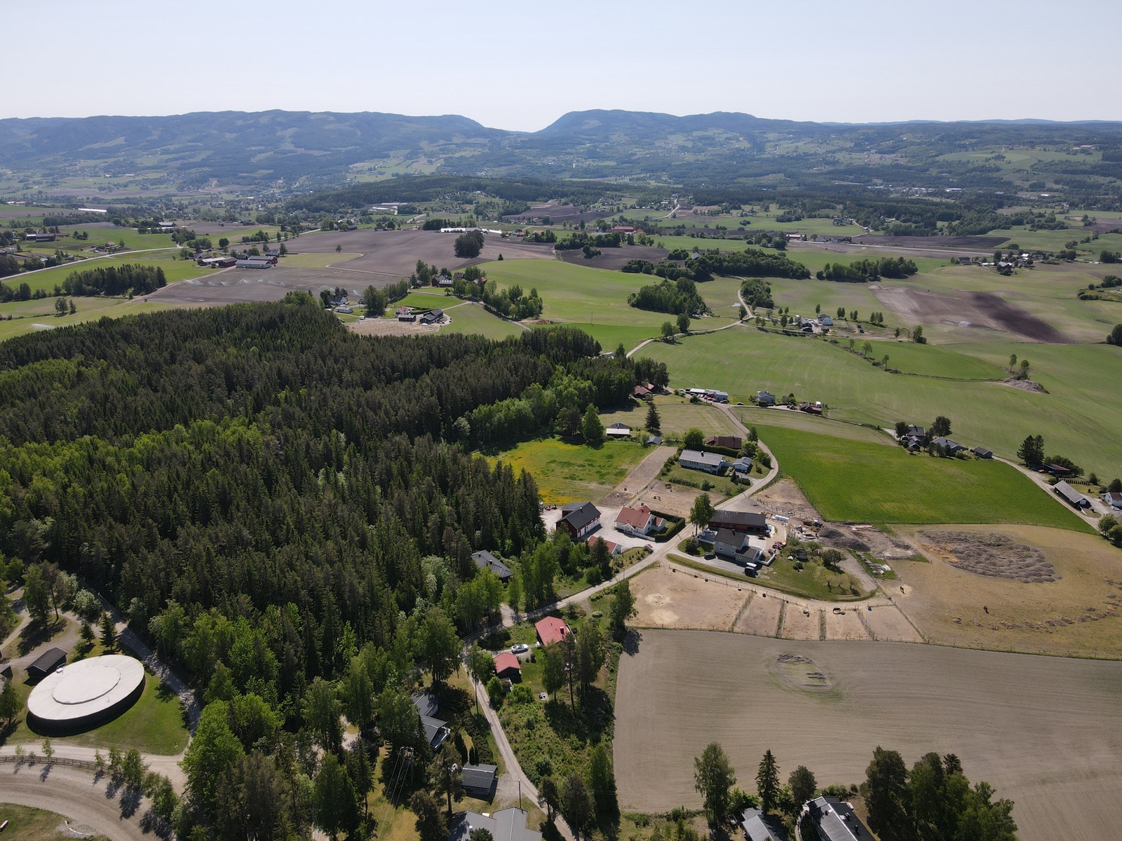 Sommerbilde - Oversiktsbilde over hele området rundt tomtene. Fine skogsområder. Galleribilde