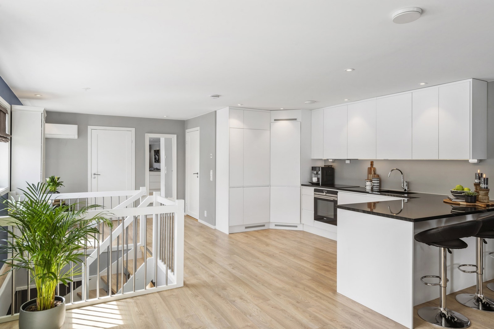 Moderne kjøkken med takhøye skap, godt med skap- og benkeplass og kjølehjørne fra Norcool. Galleribilde