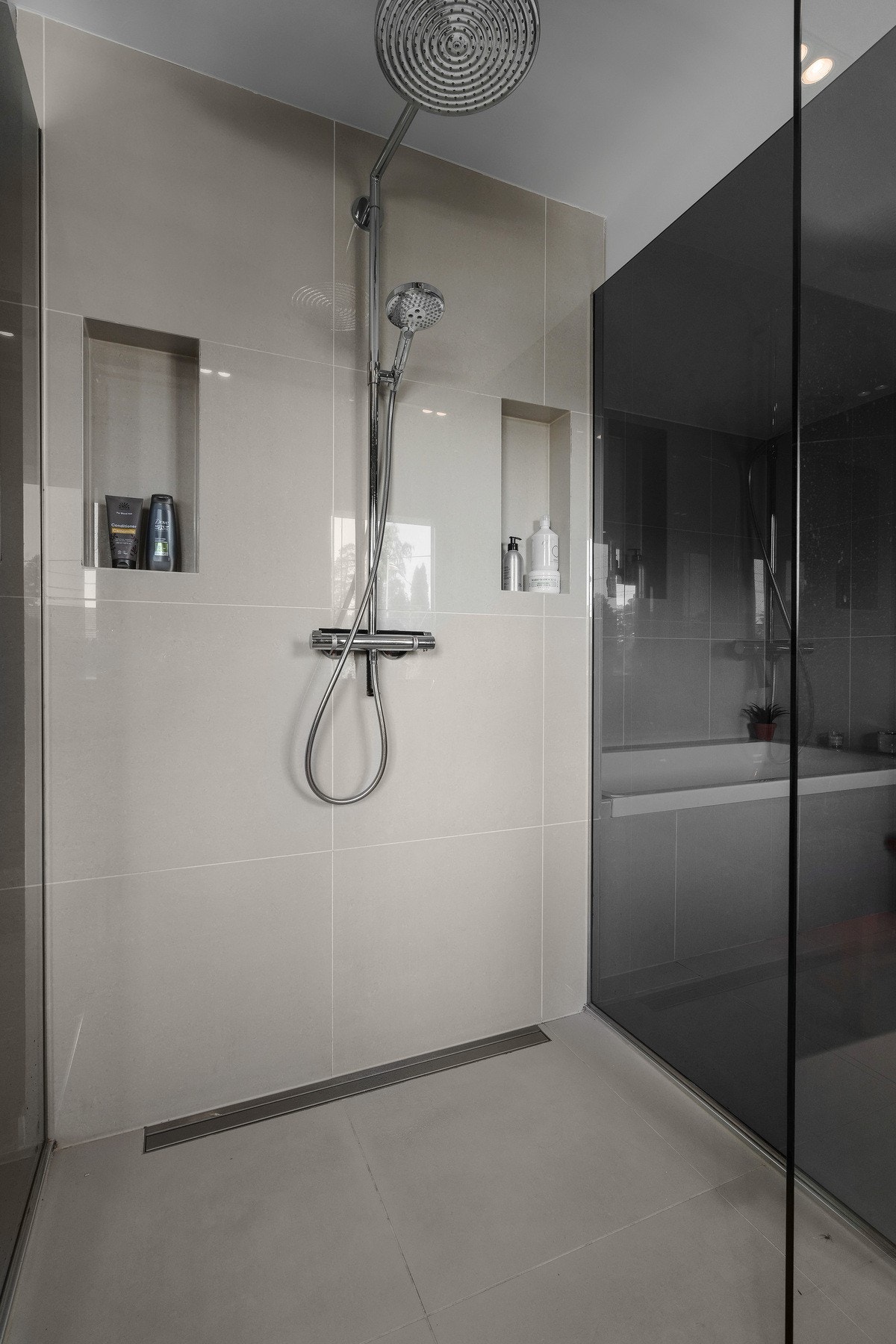 Stort dusjrom med sotede selvvaskende vegger tilknyttet hovedsoverom Galleribilde