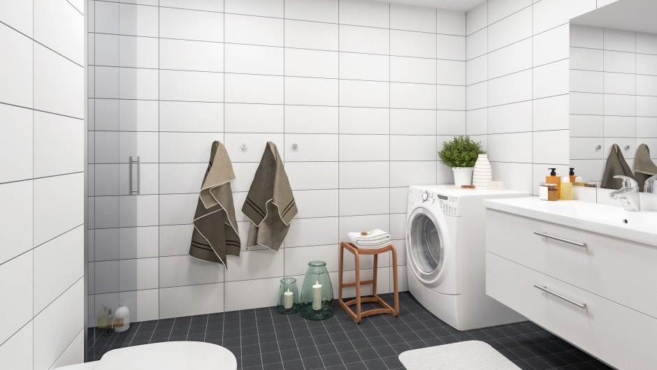 Bad med stor dusjnisje, vegghengt WC og servant med skuffer. Opplegg for vaskemaskin og tørketrommel. Galleribilde