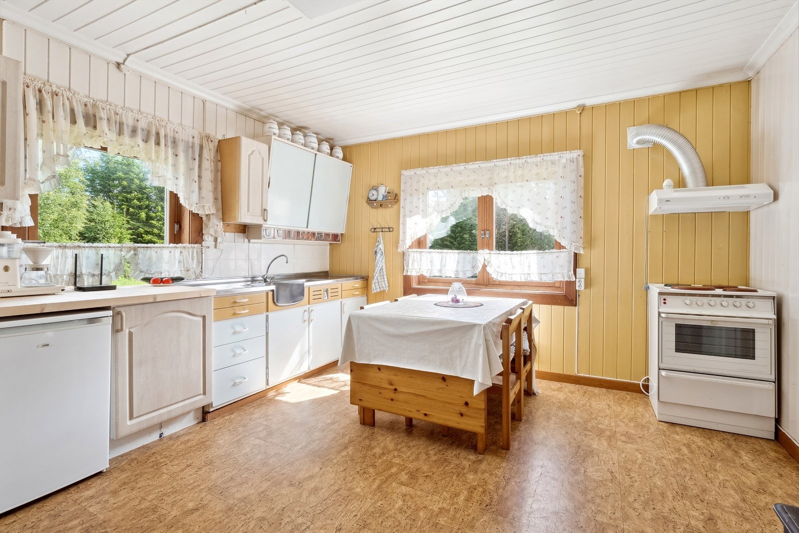 Kjøkkenet har vindusflater mot to ulike himmelretninger som sørger for et fint lysinnslipp, samt en eldre vedovn som varmer godt. På kjøkkenet har du god plass til et spisebord som gjør at også kjøkkenet blir et naturlig oppholdsrom og samlingspunkt. Galleribilde
