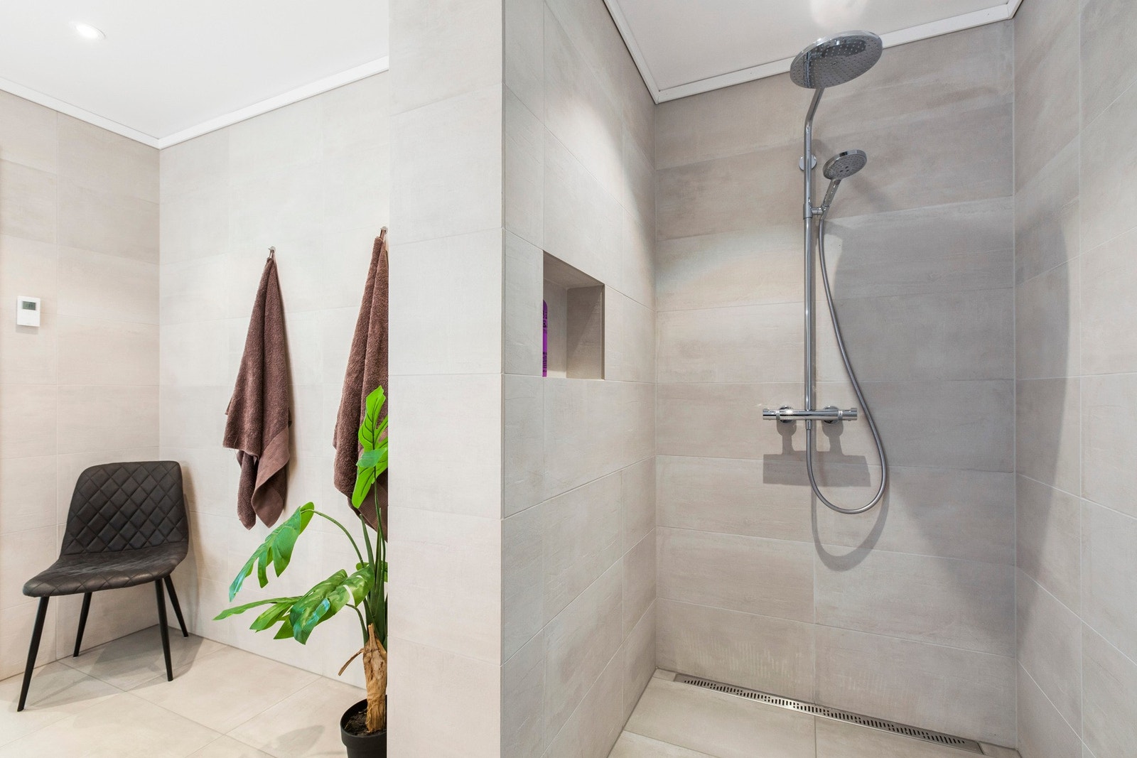 Det største baderommet er innredet med en romslig dusj, dobbel servant, vegghengt toalett og plass for badekar. Galleribilde