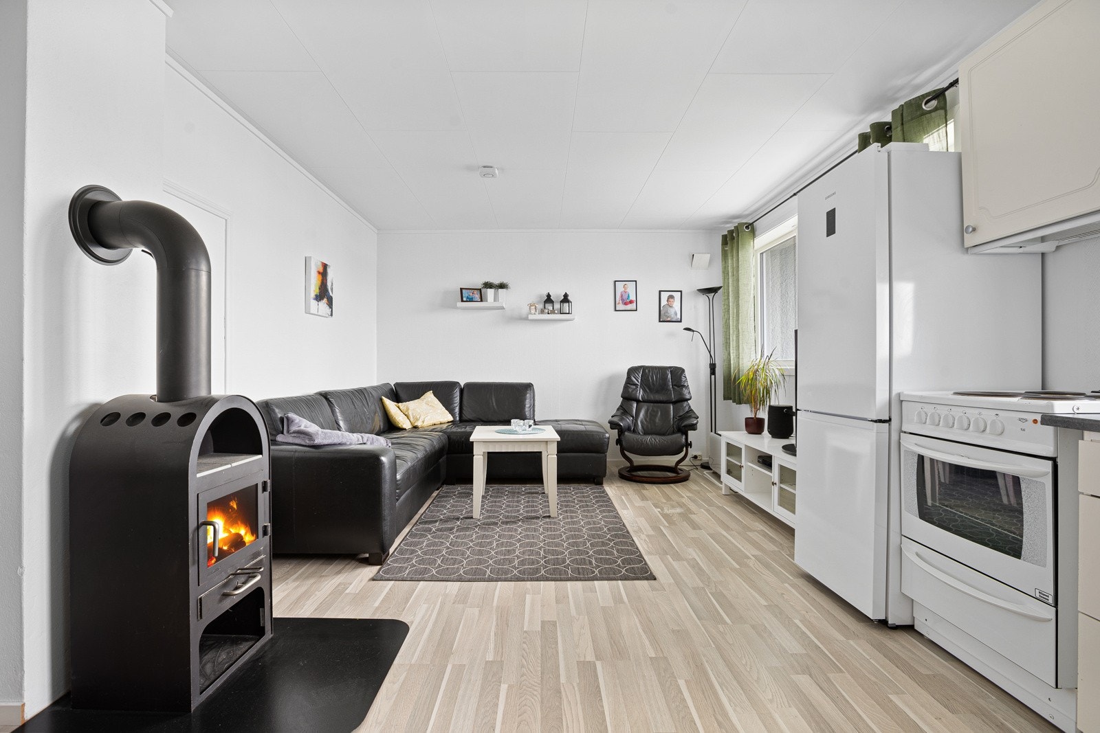 Romslig og åpen stue-/kjøkkenløsning. Egen peis her og! Galleribilde