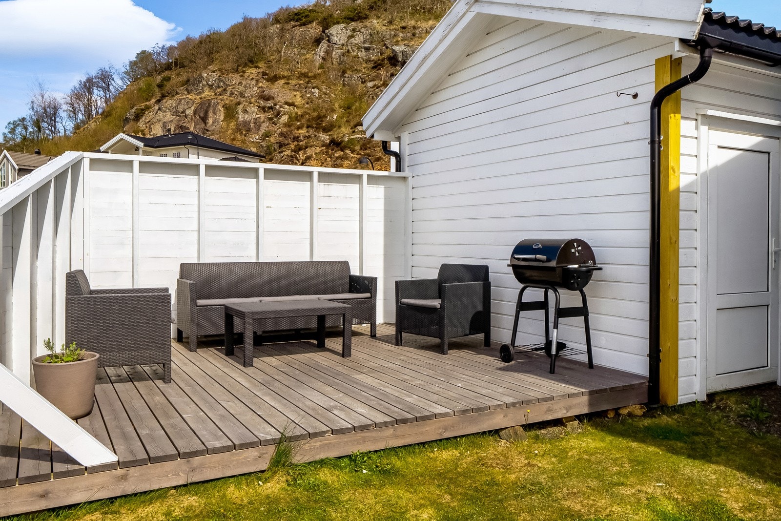 Uteplass bak carporten med praktisk bod for lagring. Galleribilde