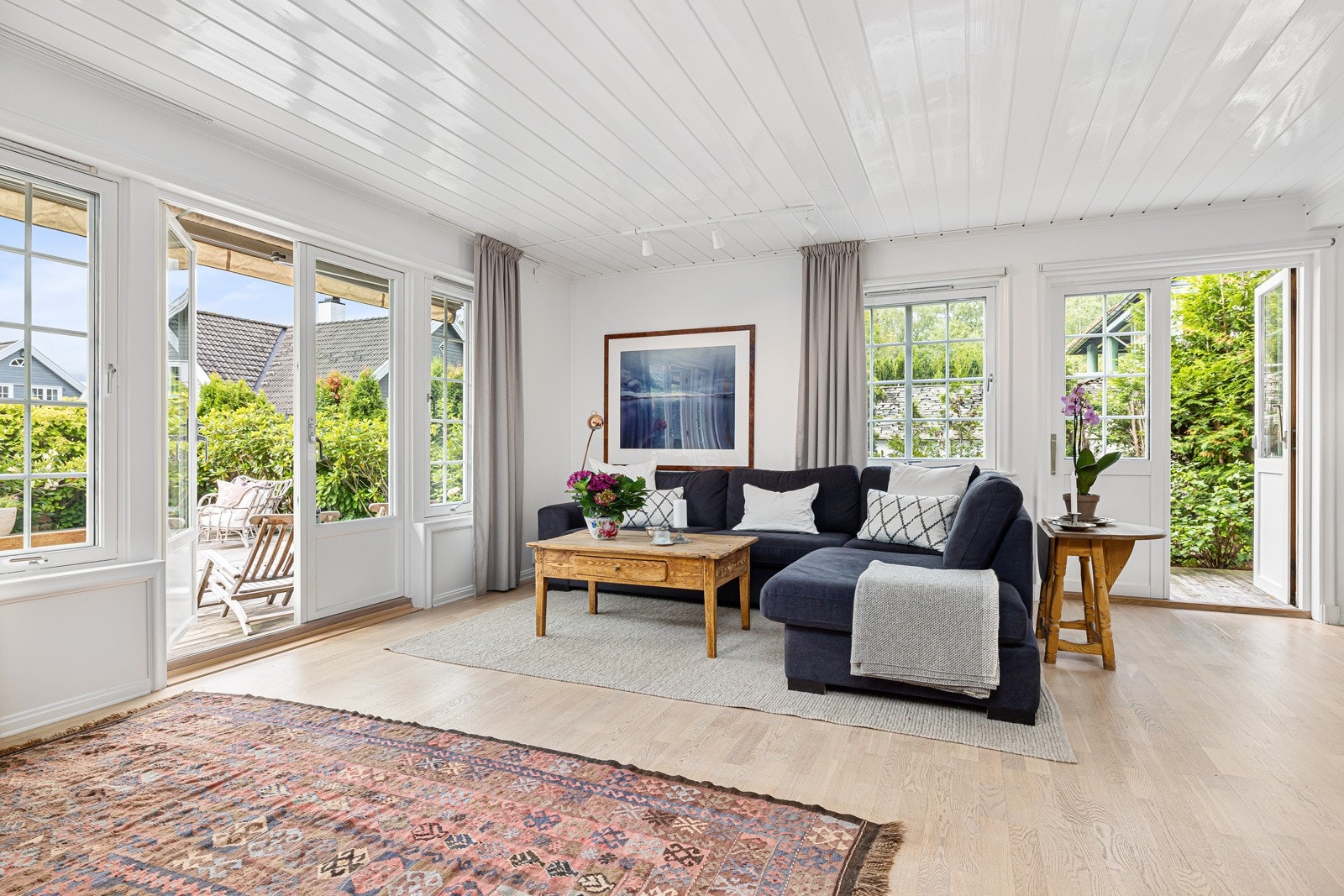 Stuen oppleves som svært tiltalende der rommet bades i lys fra store vinduer i tre ender. Galleribilde