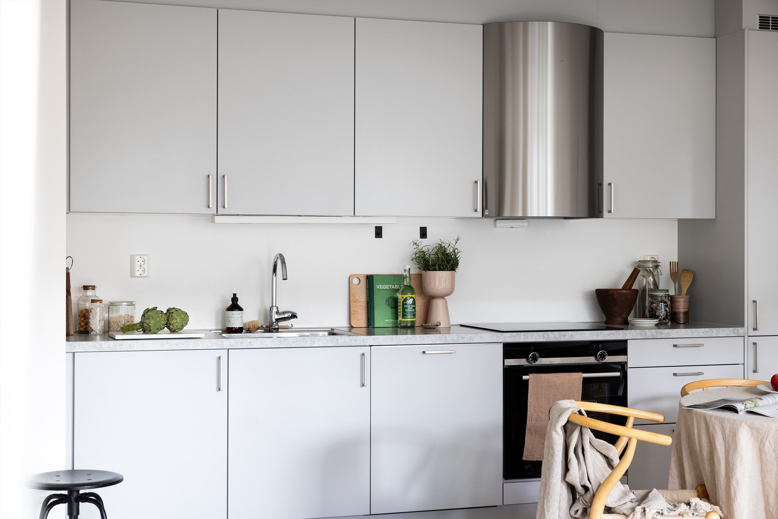 Integrerte hvitevarer som oppvaskmaskin, stekeovn og induksjon koketopp med ventilator over samt kombiskap Galleribilde