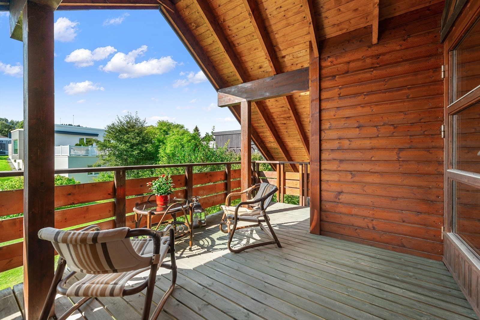 Flott veranda i andre etasjen med utsikt over tomten. Galleribilde